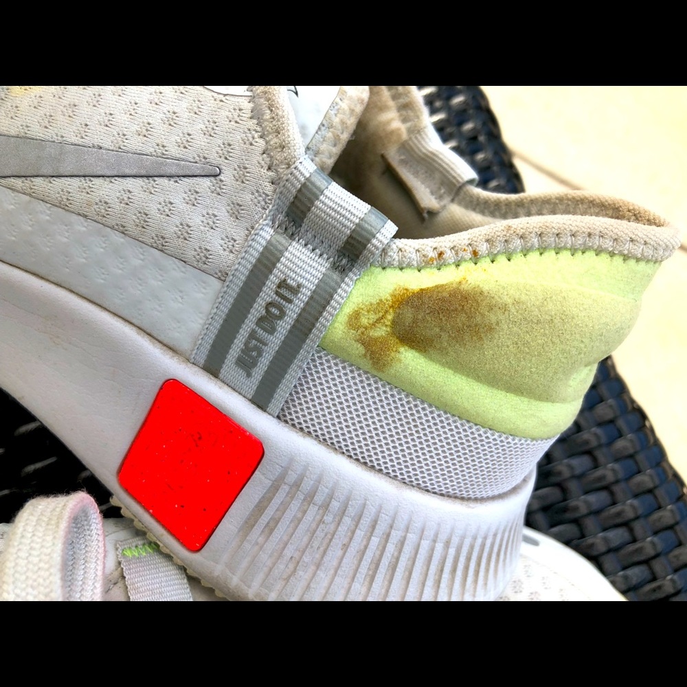White, green, and orange tennis shoes.
